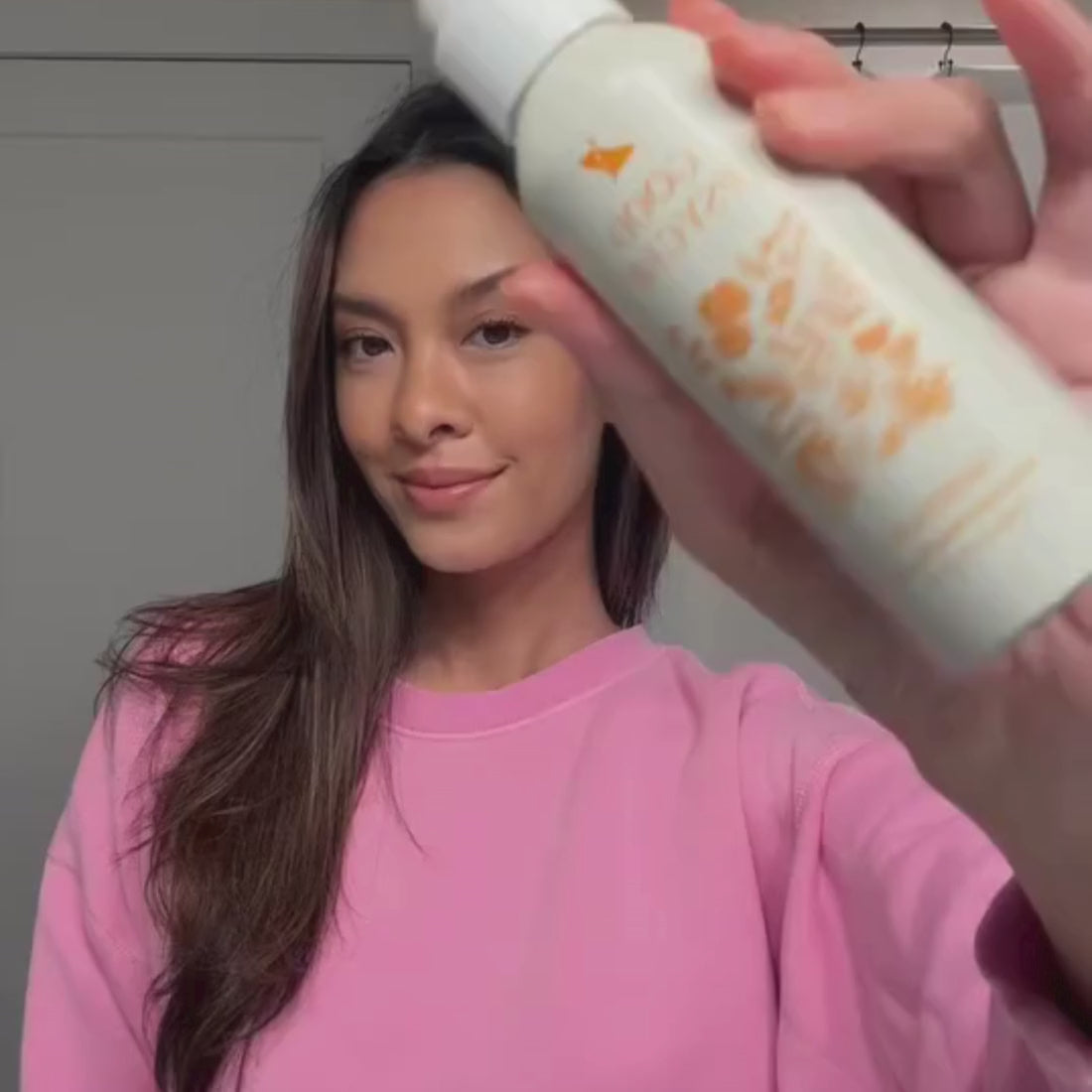 woman using good psyche glisten up to mist her face