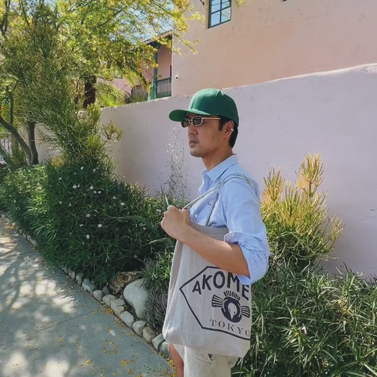 This is a video of a person using the Sidekick euphoric mouth spray. He is holding the bottle in front of his mouth, spraying 3 times and then putting the bottle into his bag. 