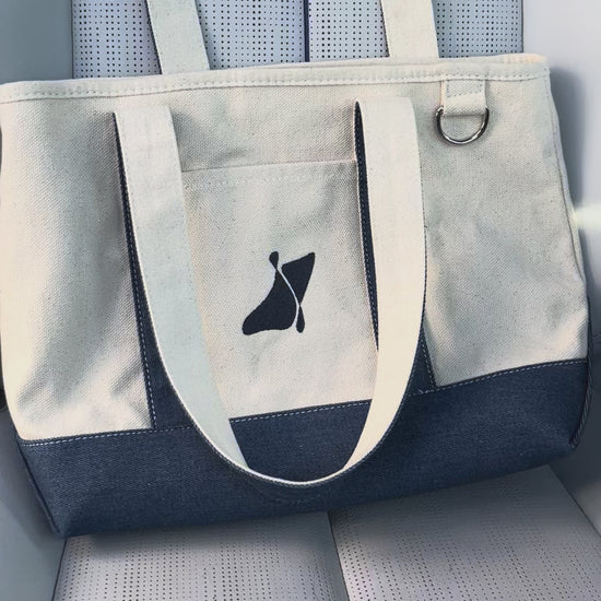 Placing the Good Psyche magazine inside the east coast tote bag 
